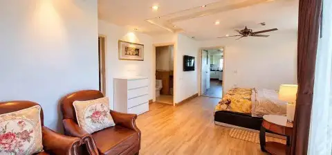 1 Bedroom Condo for Rent at Porch Land 2 bedroom with leather armchairs, dresser, and ensuite bathroom view
