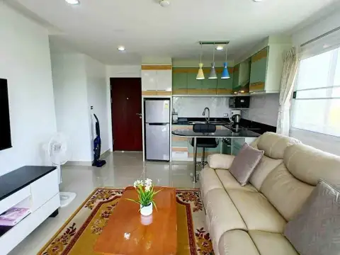 1 Bedroom Condo for Rent at Porch Land 2 living area facing kitchen with fridge and bar stools