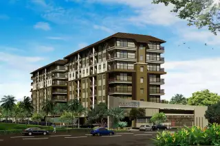 Porch Land 2 condominium building exterior with multiple balconies, entrance gate, road, cars, and lush landscaping under a blue sky.