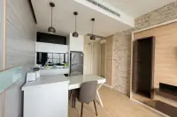 1 Bedroom Condo for Sale at Cetus Beachfront kitchen and dining area with stone accent wall, built-in shelving and city view window