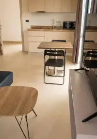 1 Bedroom Condo for Sale at Sea Zen kitchen and dining area with wooden table and coffee table