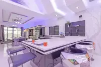 4 Bedroom House for Sale & Rent in Pratumnak Hill modern kitchen with large white island, mirrored bar stools, and open-plan dining area