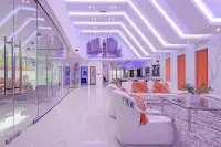 4 Bedroom House for Sale & Rent in Pratumnak Hill spacious living room with LED ceilings, glass walls, white sofas, and Charlie Chaplin ceiling mural