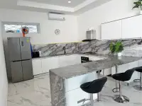 6 Bedroom House for Sale & Rent in Pratumnak Hill modern kitchen with marble countertop and bar stools