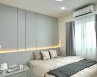 3 Bedroom House for Sale in East Pattaya master bedroom with upholstered headboard wall and sheer curtains