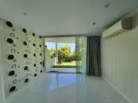 1 Bedroom Condo for Sale at Pure Sunset Beach balcony with patterned accent wall and garden view with ocean glimpse