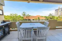 1 Bedroom Condo for Sale & Rent at View Talay Residence 1&2 spacious balcony with outdoor dining table and tropical garden views