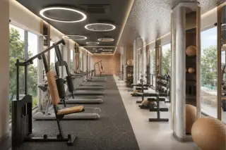 Spectra Residence fully equipped fitness center with treadmills, weight machines, circular LED lights and garden views
