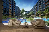 3 Bedroom Condo for Sale at Zenith 2 outdoor seating area with two chairs, coffee table, and large swimming pool.