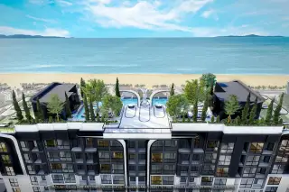 Embassy Life aerial view of a modern high-rise condo building with terraced levels, rooftop pools, and lush landscaping.