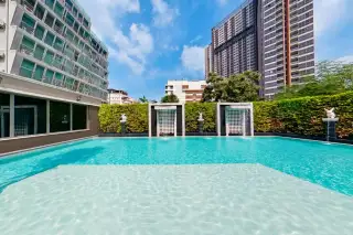 Arcadia Center Suite swimming pool with decorative waterfall walls and statues between towers
