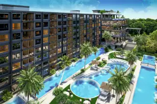 Zenith 2 aerial view of the condo complex with multiple swimming pools, lush tropical landscaping, and rooftop amenities.