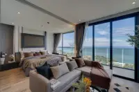 1 Bedroom Condo for Sale at Andromeda Condominium stylish bedroom with king bed, L-shaped sofa, and panoramic ocean view