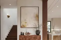 3 Bedroom House for Sale at Solava Pattaya entryway with dark wood staircase, abstract gold artwork, and burl wood console
