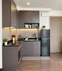 2 Bedroom Condo for Sale at Pattaya Posh compact kitchen with dark cabinetry and mosaic tile backsplash