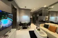 1 Bedroom Condo for Sale at Zenith Pattaya spacious living and dining area with mirror wall, cream sofa, and built-in kitchen