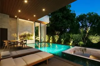 Baan Mae Residence 69 modern townhouses with marble facades, wooden screens, and ground-level parking.