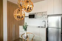 2 Bedroom Condo for Sale at Veranda Residence Pattaya modern kitchen with stainless steel fridge and rope pendant lights.