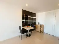 1 Bedroom Condo for Sale at The Vision dining nook with small table, chairs, and mirrored wall reflecting kitchen