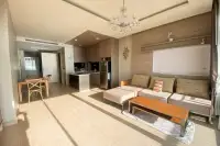 2 Bedroom Condo for Rent at Cetus Beachfront spacious open-plan living and dining area with crystal chandelier, sofa, and modern kitchen