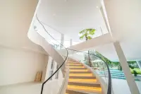 8 Bedroom House for Sale in Huai Yai elegant curved staircase with glass balustrade and LED-lit steps
