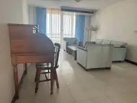 2 Bedroom Condo for Rent at Rama Harbour View living room with antique desk, blue armchairs and bright window
