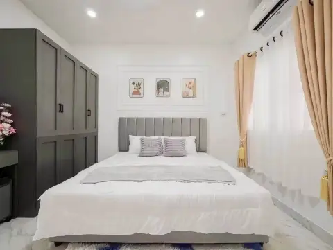 4 Bedroom House for Sale at Raviporn City Home bedroom with wardrobe closet and wall art above bed