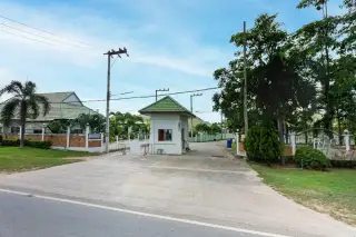 Phonthep Garden Ville 2 gated community entrance with security booth and palm tree-lined driveway in Pattaya