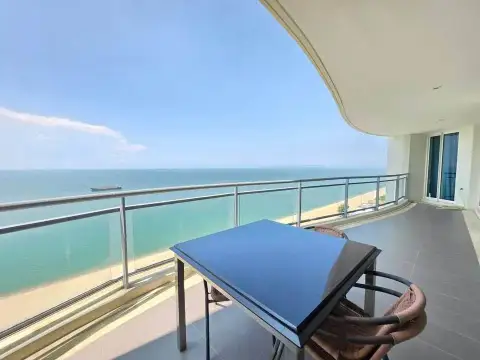3 Bedroom Condo for Rent at Reflection Jomtien Beach private balcony with table, chairs and panoramic sea view