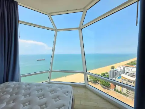3 Bedroom Condo for Rent at Reflection Jomtien Beach bedroom with floor-to-ceiling windows overlooking the beach