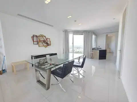 3 Bedroom Condo for Rent at Reflection Jomtien Beach dining area with glass table and view toward open kitchen
