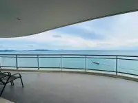 3 Bedroom Condo for Sale at Reflection Jomtien Beach private balcony with panoramic ocean view and lounge chair