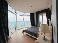 3 Bedroom Condo for Sale at Reflection Jomtien Beach master bedroom with floor-to-ceiling windows and sea view