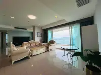 3 Bedroom Condo for Sale at Reflection Jomtien Beach living room with elegant sofas and balcony ocean view