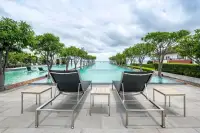 1 Bedroom Condo for Sale at Reflection Jomtien Beach infinity pool with lounge chairs and sea view