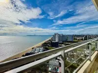 2 Bedroom Condo for Sale at Reflection Jomtien Beach high-floor balcony view of beach and Pattaya skyline