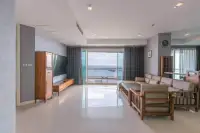3 Bedroom Condo for Sale at Reflection Jomtien Beach spacious living room with ocean view through sliding glass doors