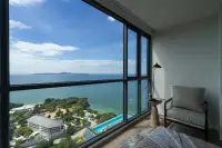 2 Bedroom Condo for Sale at Andromeda Condominium bedroom seating area with large window view of infinity pool and Pattaya coastline