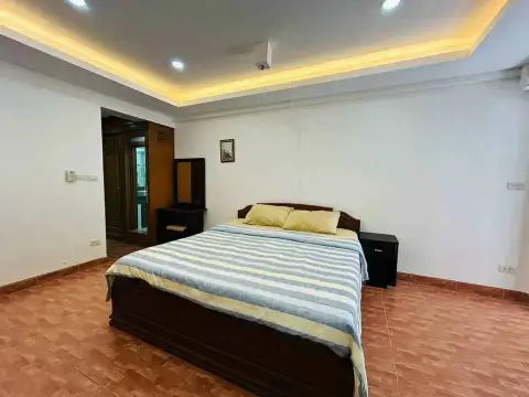 1 Bedroom Condo for Sale at Rimhad Jomtien Condominium bedroom with dark wood bed frame and recessed ceiling lighting