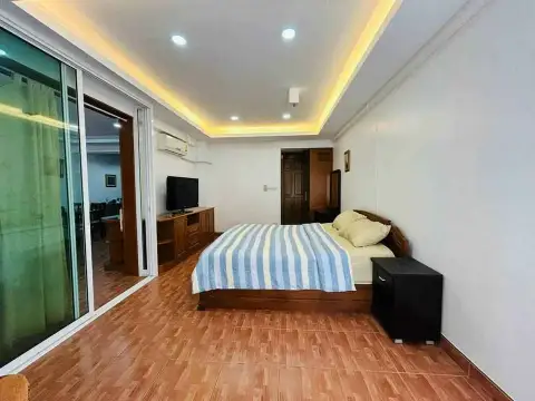 1 Bedroom Condo for Sale at Rimhad Jomtien Condominium spacious bedroom with balcony access and wood flooring