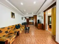 1 Bedroom Condo for Sale at Rimhad Jomtien Condominium open living and dining area with patterned sofa and wood-tone flooring