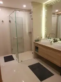 2 Bedroom Condo for Sale at The Riviera Jomtien bathroom with glass shower and wooden double vanity