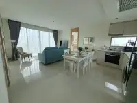 2 Bedroom Condo for Sale at The Riviera Jomtien open-plan living and dining area with built-in kitchen and city view