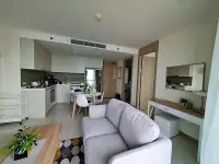 2 Bedroom Condo for Sale at The Riviera Jomtien open-plan kitchen with white cabinets and dining area