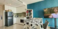 1 Bedroom Condo for Sale at The Riviera Jomtien fully equipped kitchen with stainless steel fridge and teal accent wall