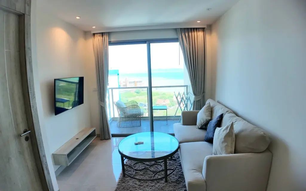 1 Bedroom Condo for Sale & Rent at Riviera Monaco living room with sea view balcony and beige sofa
