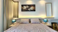 1 Bedroom Condo for Rent at Riviera Monaco bedroom with checkered bedding, bedside lamps, and wall art