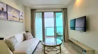 1 Bedroom Condo for Rent at Riviera Monaco living room with white sofa, glass coffee table, and balcony access