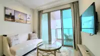 1 Bedroom Condo for Rent at Riviera Monaco lounge space with nautical wall art and city view balcony