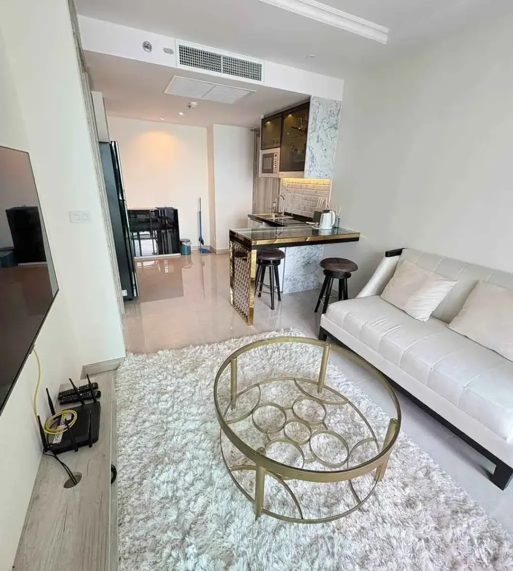 1 Bedroom Condo for Rent at Riviera Monaco living room with white sofa, marble kitchen counter and bar stools